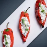 Speca me gjize, albanska kuhinja, albanska jela, tradicionalna albanska hrana, punjene paprike, paprika sa sirom, albanski recepti, gjize sir, balkanska kuhinja, jela iz Albanije, tradicionalni recepti, pečene paprike, Speca me gjize, Albanian cuisine, Albanian food, traditional Albanian dishes, stuffed peppers, peppers with cheese, Albanian recipes, gjize cheese, Balkan cuisine, food from Albania, traditional recipes, roasted peppers,